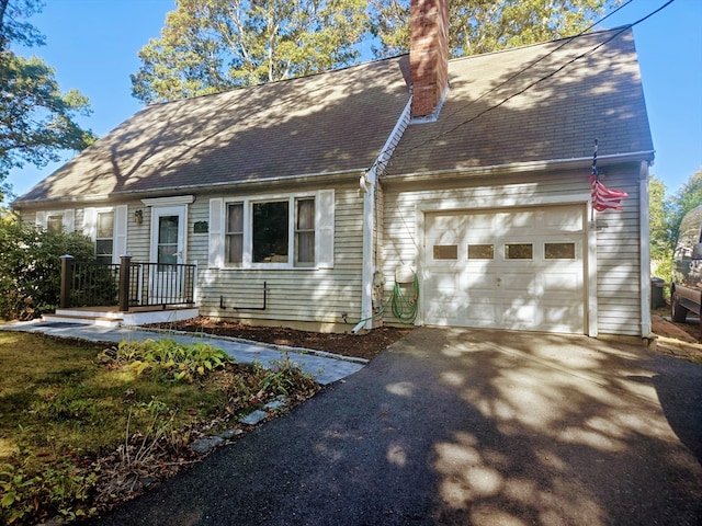 new england style home with a garage