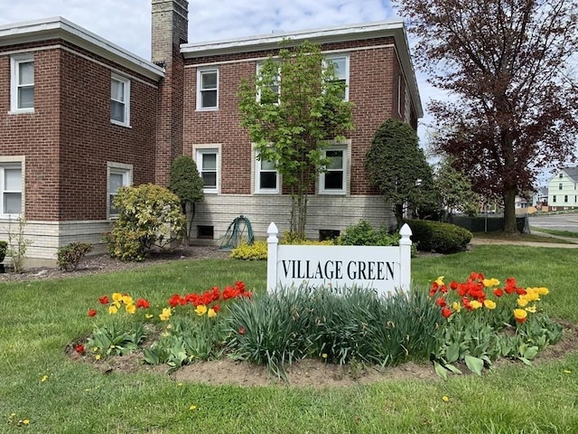 community / neighborhood sign with a yard