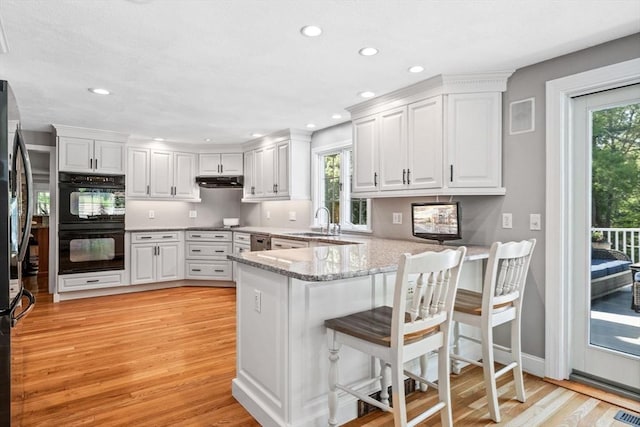 20 Stagecoach Rd, Topsfield, MA 01983 - kitchen featuring appliances with stainless steel finishes, a sink, a peninsula, light wood-style flooring, and plenty of natural light