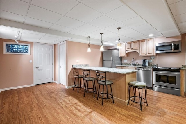 20 Stagecoach Rd, Topsfield, MA 01983 - kitchen with appliances with stainless steel finishes, a kitchen breakfast bar, light wood-type flooring, a peninsula, and a drop ceiling