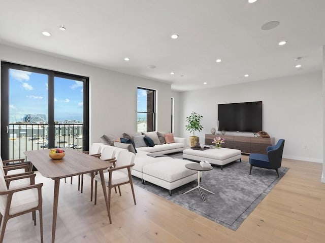 living room featuring light wood-type flooring and a wealth of natural light