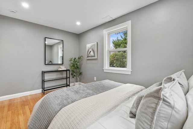 bedroom featuring recessed lighting, baseboards, and wood finished floors