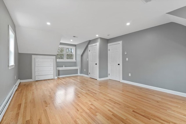 bonus room featuring baseboards, a baseboard radiator, and light wood-style flooring