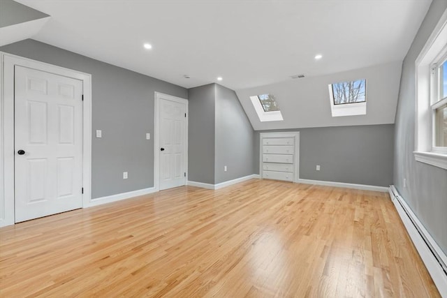 bonus room with light wood-style flooring, recessed lighting, a baseboard radiator, visible vents, and lofted ceiling with skylight