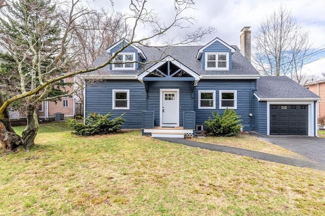 view of front of property featuring driveway, a chimney, a front yard, an attached garage, and a shingled roof