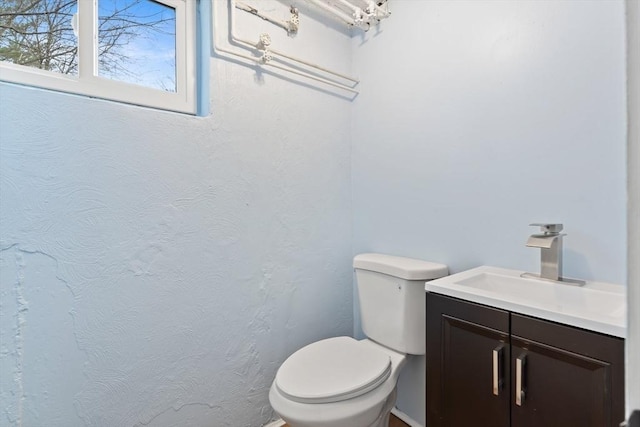 bathroom with toilet and vanity