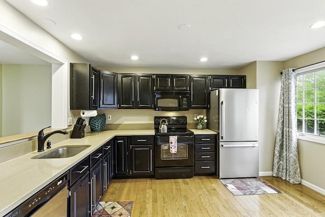 14 Weybridge Ln Unit 14, Hopkinton, MA 01748 - kitchen with black appliances, a sink, dark cabinets, light countertops, and recessed lighting