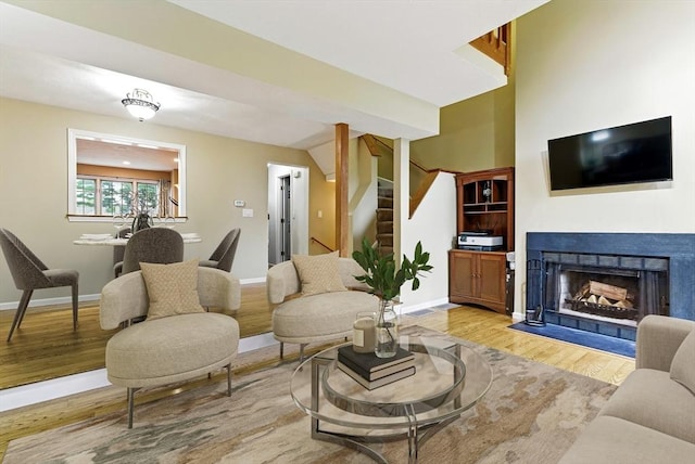 14 Weybridge Ln Unit 14, Hopkinton, MA 01748 - living area with light wood-style floors, stairs, baseboards, and a fireplace with flush hearth