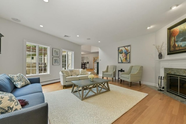 1 Fox Hunt Ln, Winchester, MA 01890 - living room with baseboard heating, light wood-style flooring, a premium fireplace, and recessed lighting