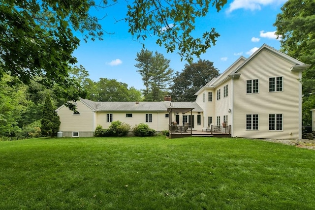 1 Fox Hunt Ln, Winchester, MA 01890 - rear view of property featuring a lawn, a wooden deck, and a chimney