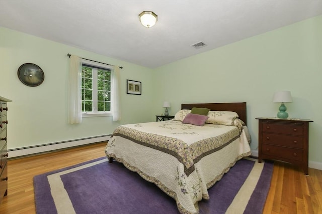 1 Fox Hunt Ln, Winchester, MA 01890 - bedroom with a baseboard heating unit and wood finished floors
