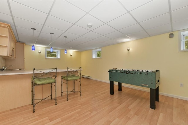 1 Fox Hunt Ln, Winchester, MA 01890 - rec room featuring a baseboard heating unit, light wood finished floors, and a paneled ceiling