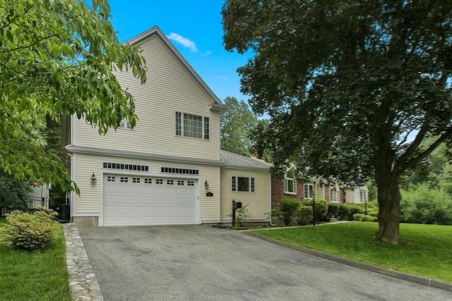 1 Fox Hunt Ln, Winchester, MA 01890 - view of front of home featuring a garage, asphalt driveway, and a front yard