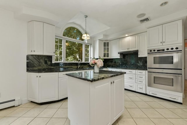 1 Fox Hunt Ln, Winchester, MA 01890 - kitchen with stainless steel double oven, light tile patterned floors, baseboard heating, and white cabinetry