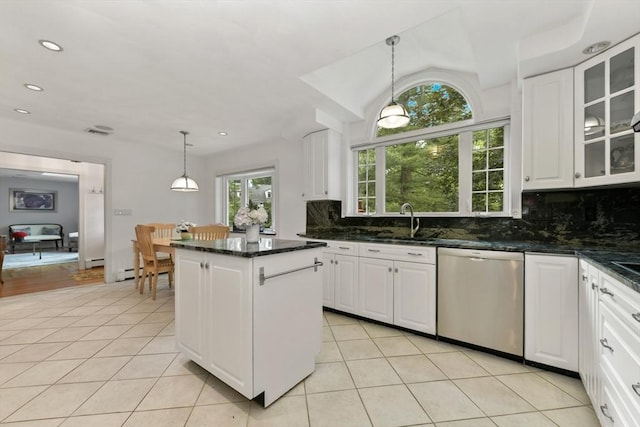 1 Fox Hunt Ln, Winchester, MA 01890 - kitchen with stainless steel dishwasher, light tile patterned flooring, backsplash, a kitchen island, and white cabinets