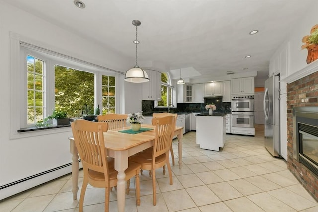 1 Fox Hunt Ln, Winchester, MA 01890 - dining area with baseboard heating, light tile patterned flooring, a brick fireplace, and recessed lighting