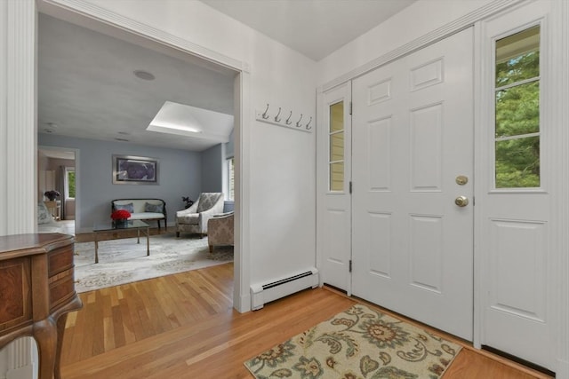 1 Fox Hunt Ln, Winchester, MA 01890 - foyer entrance featuring a baseboard radiator, a skylight, and light wood finished floors