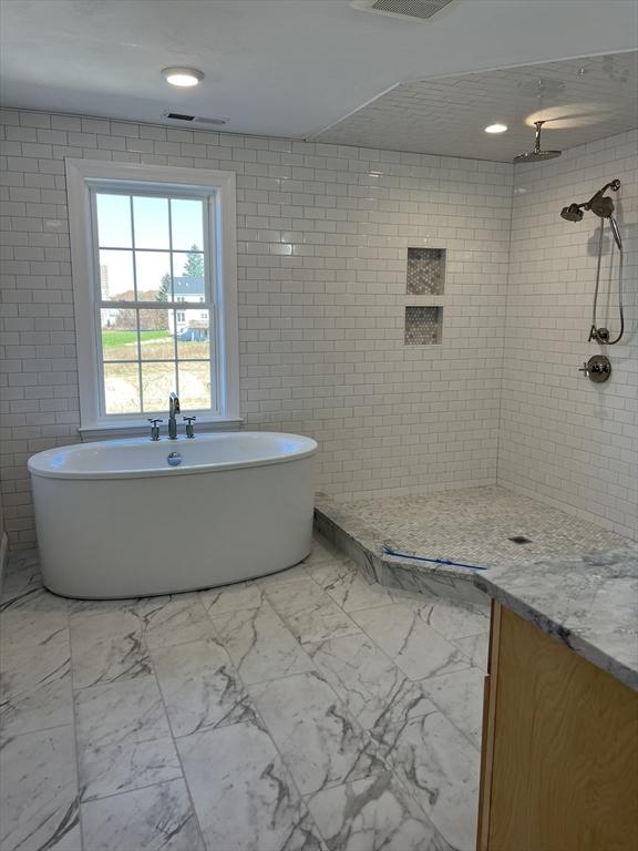 16 Clearview St, Grafton, MA 01536 - full bath with marble look tile flooring, a soaking tub, and a tile shower