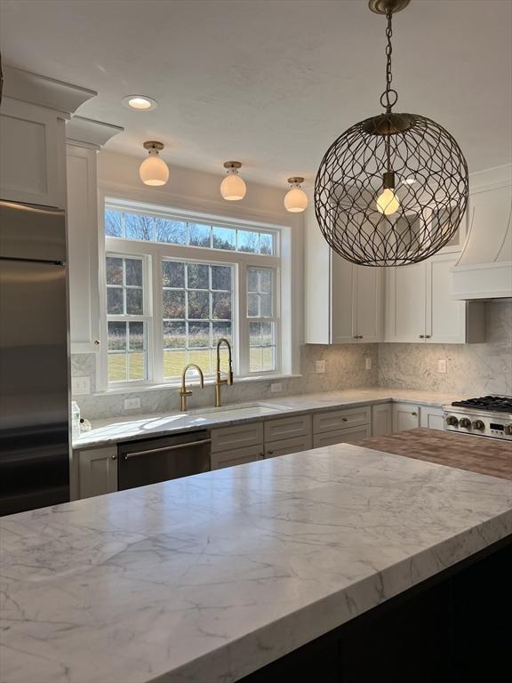16 Clearview St, Grafton, MA 01536 - kitchen featuring dishwasher, a sink, light stone countertops, backsplash, and plenty of natural light
