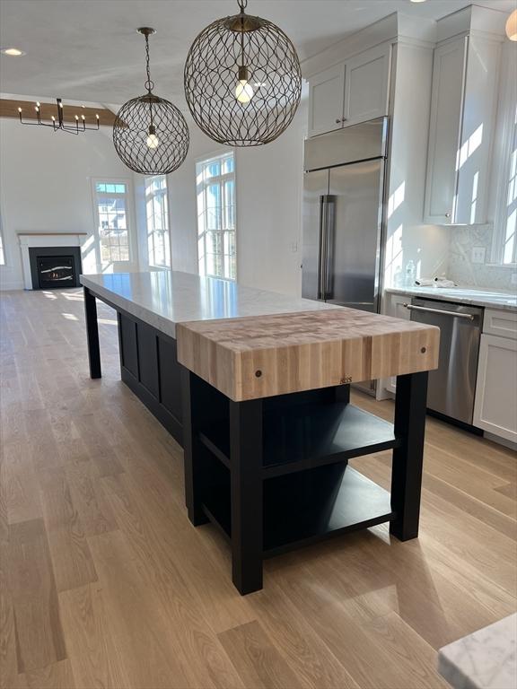 16 Clearview St, Grafton, MA 01536 - kitchen featuring appliances with stainless steel finishes, wood counters, open shelves, and plenty of natural light