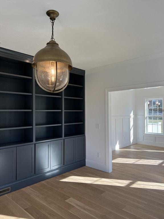 16 Clearview St, Grafton, MA 01536 - unfurnished dining area with wood finished floors, crown molding, baseboards, and built in shelves