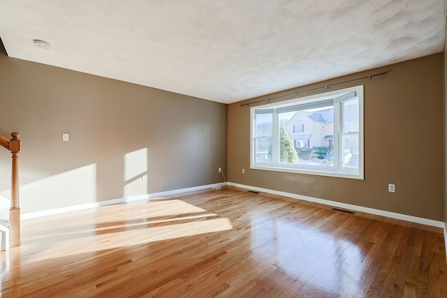 spare room featuring wood-type flooring