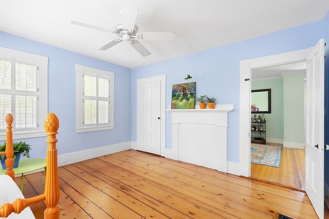foyer entrance with a ceiling fan, baseboards, and light wood finished floors