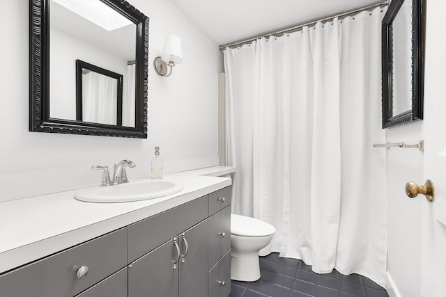 full bathroom featuring vanity, tile patterned flooring, and toilet