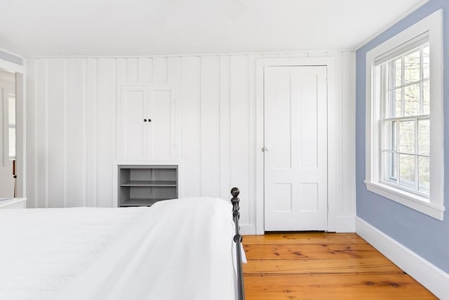 bedroom featuring baseboards and light wood-type flooring