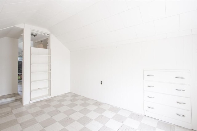 additional living space with light floors and lofted ceiling