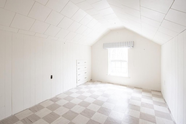 bonus room featuring lofted ceiling and light floors