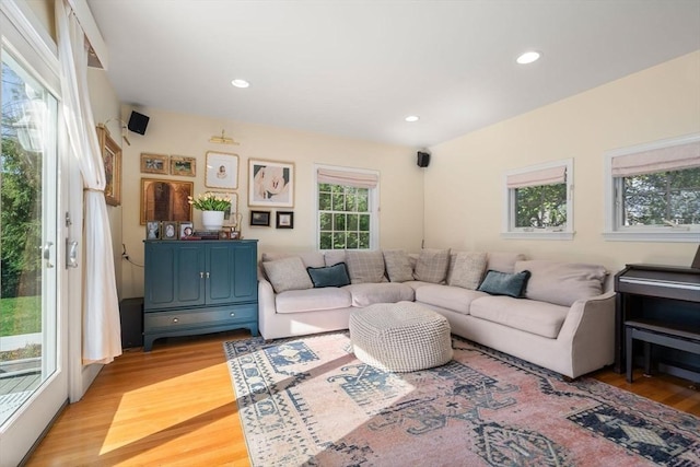 living area with recessed lighting and light wood finished floors