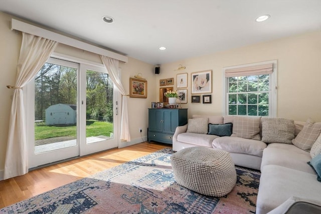living room featuring recessed lighting, a healthy amount of sunlight, and light wood-style floors