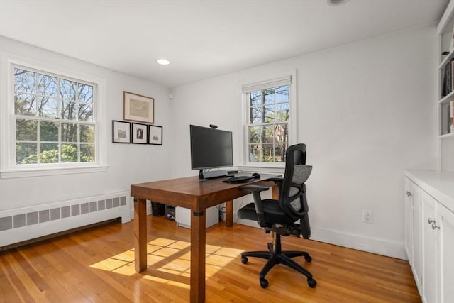 home office with radiator heating unit, baseboards, recessed lighting, and light wood-type flooring