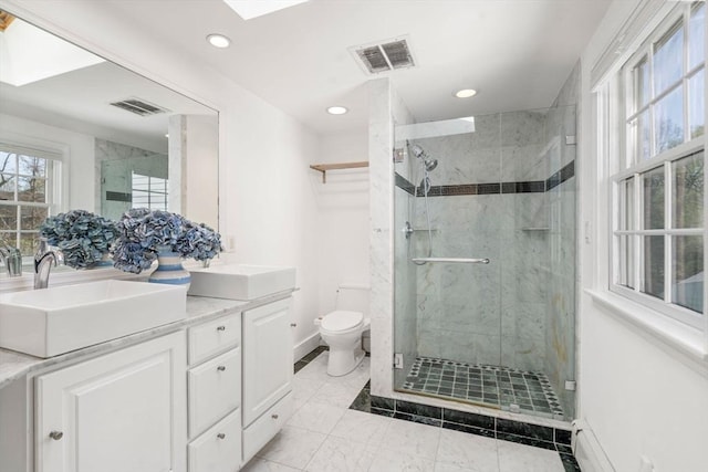 full bath featuring toilet, baseboards, visible vents, and a sink