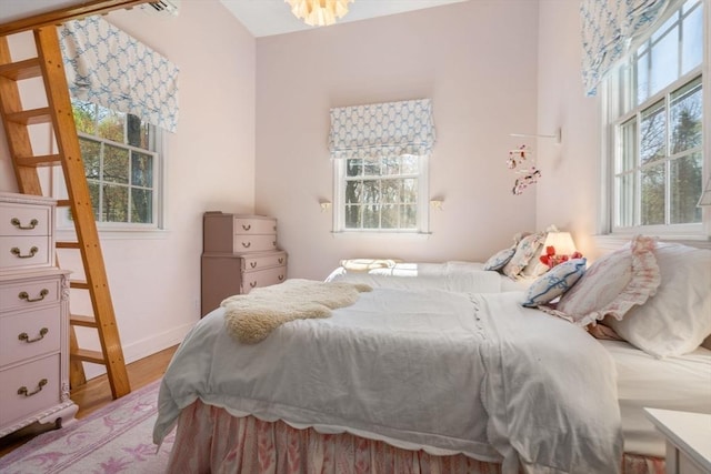 bedroom featuring baseboards and wood finished floors