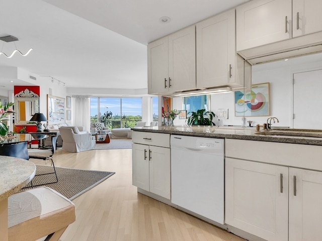 kitchen with white cabinets, white dishwasher, light wood-type flooring, and sink