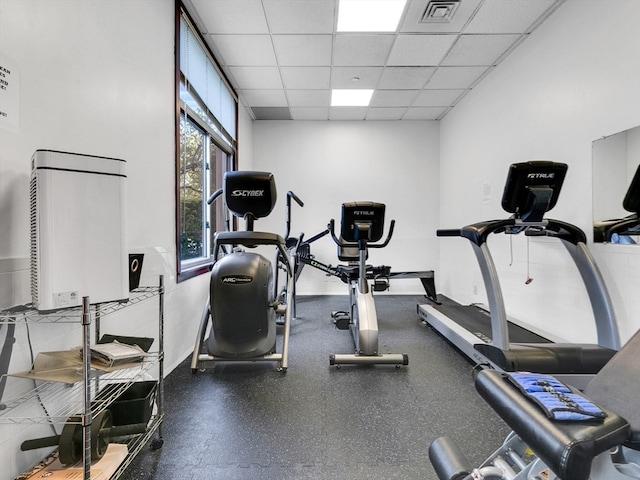 workout room with a paneled ceiling