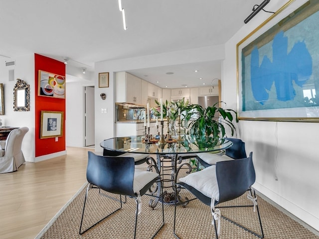 dining space featuring light hardwood / wood-style floors