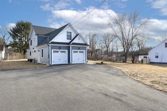 exterior space featuring cooling unit, driveway, and fence