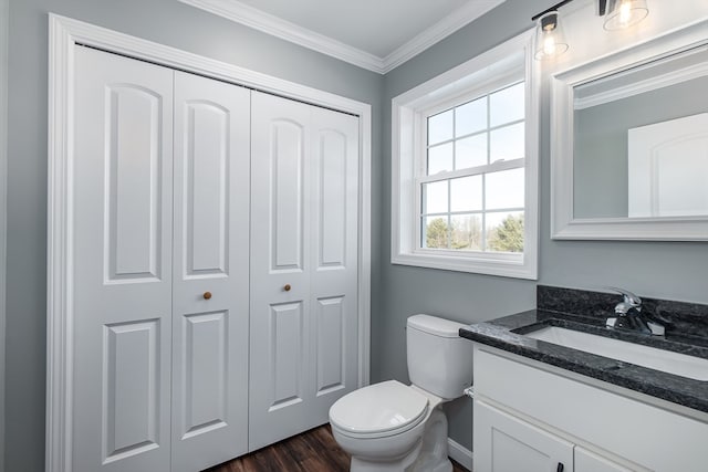 bathroom with hardwood / wood-style flooring, vanity, toilet, and crown molding