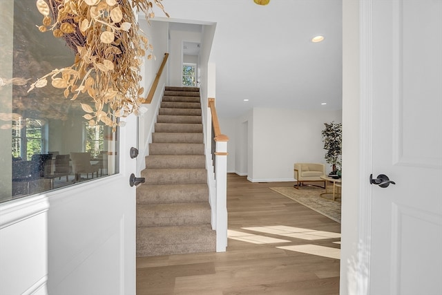 stairs featuring hardwood / wood-style flooring