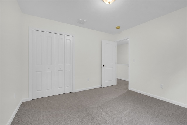 unfurnished bedroom with a closet and carpet