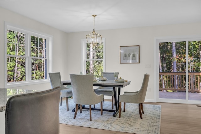 dining room featuring an inviting chandelier and light hardwood / wood-style flooring