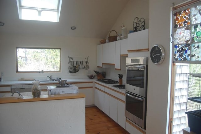 135 Marven Way, Wellfleet, MA 02667 - kitchen with stainless steel double oven, plenty of natural light, light countertops, and lofted ceiling