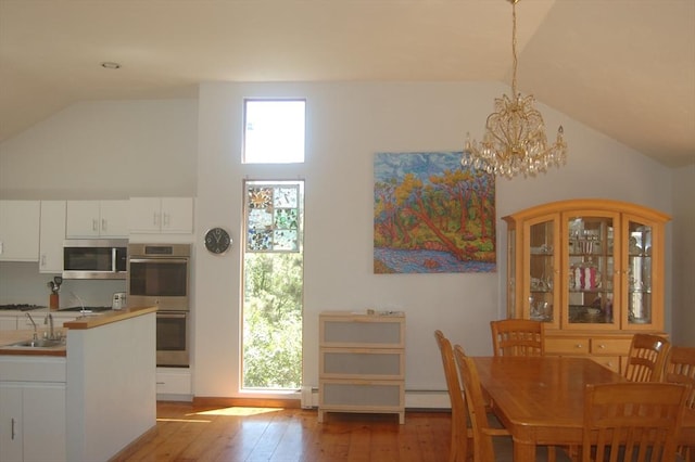 135 Marven Way, Wellfleet, MA 02667 - dining area featuring vaulted ceiling, light wood-style flooring, and a chandelier