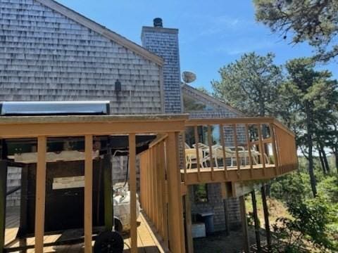135 Marven Way, Wellfleet, MA 02667 - back of house featuring a chimney, a wooden deck, and a shingled roof
