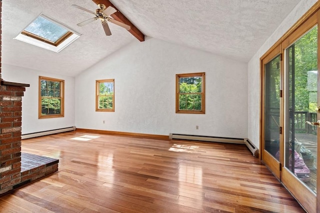 199 Old Westboro Rd, Grafton, MA 01536 - unfurnished living room featuring a baseboard heating unit, ceiling fan, hardwood / wood-style floors, a textured ceiling, and a skylight