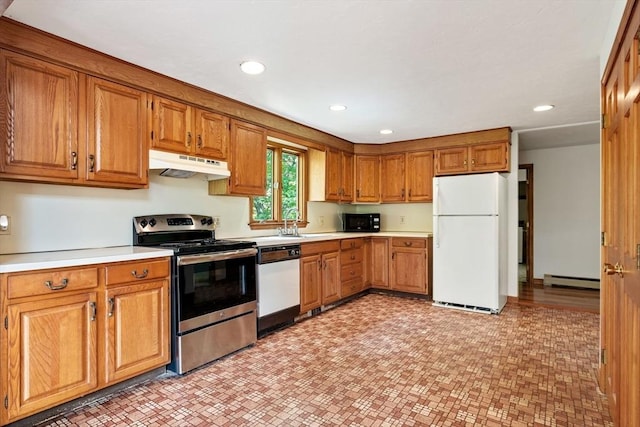 199 Old Westboro Rd, Grafton, MA 01536 - kitchen with white appliances, under cabinet range hood, brown cabinets, light countertops, and a baseboard radiator