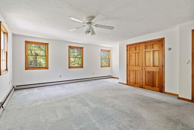199 Old Westboro Rd, Grafton, MA 01536 - unfurnished bedroom with carpet floors, a baseboard radiator, a textured ceiling, and a ceiling fan